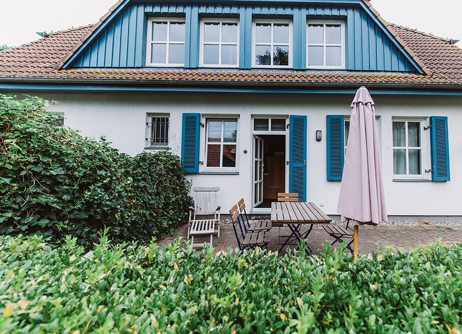 Das Haus am Schilf mit blauen Fensterläden und Terrasse